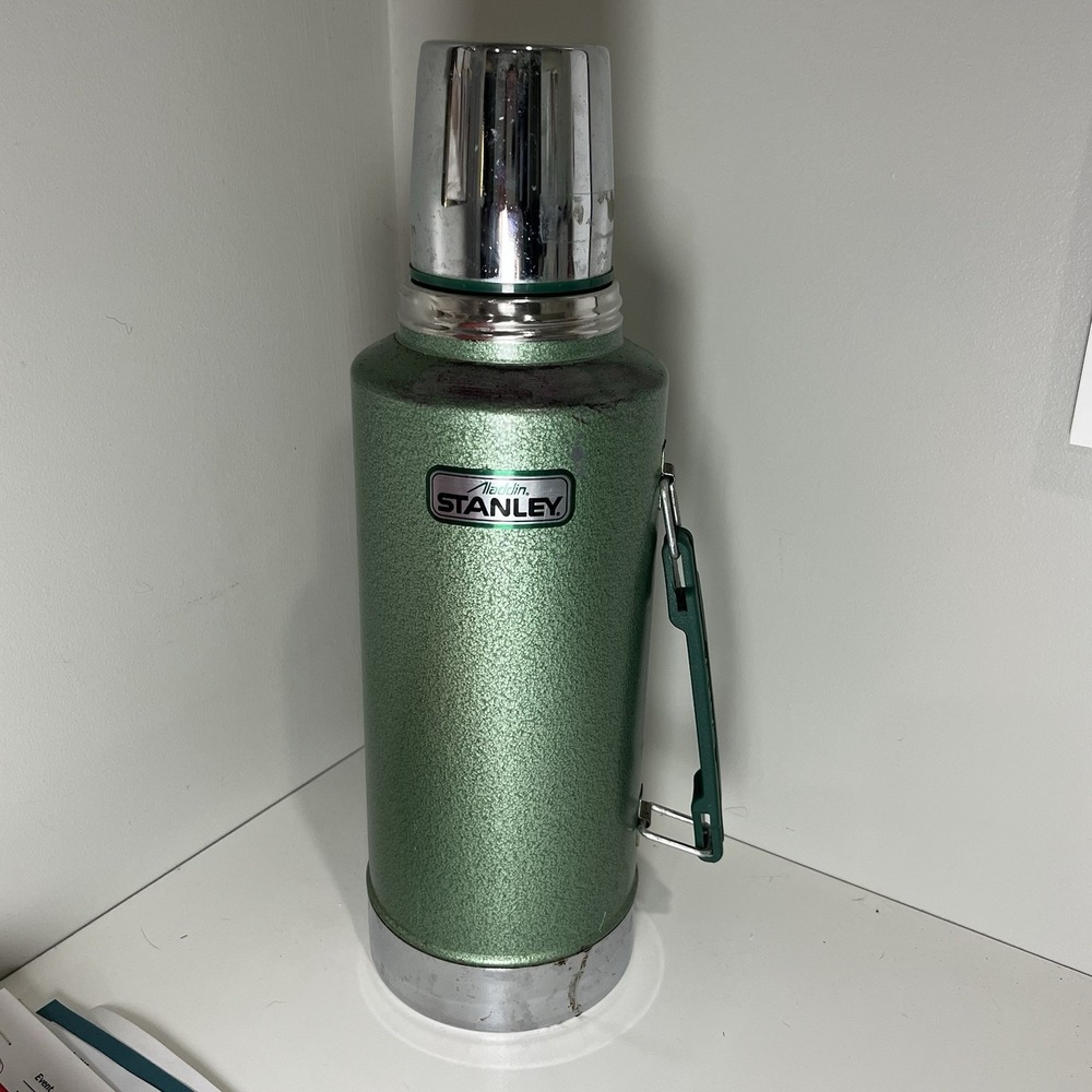 vintage Aladdin Stanley vacuum bottle, specifically a green hammertone model